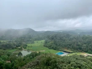 Travel essentials packed for a nature vacation in Coorg including trekking shoes and outdoor gear